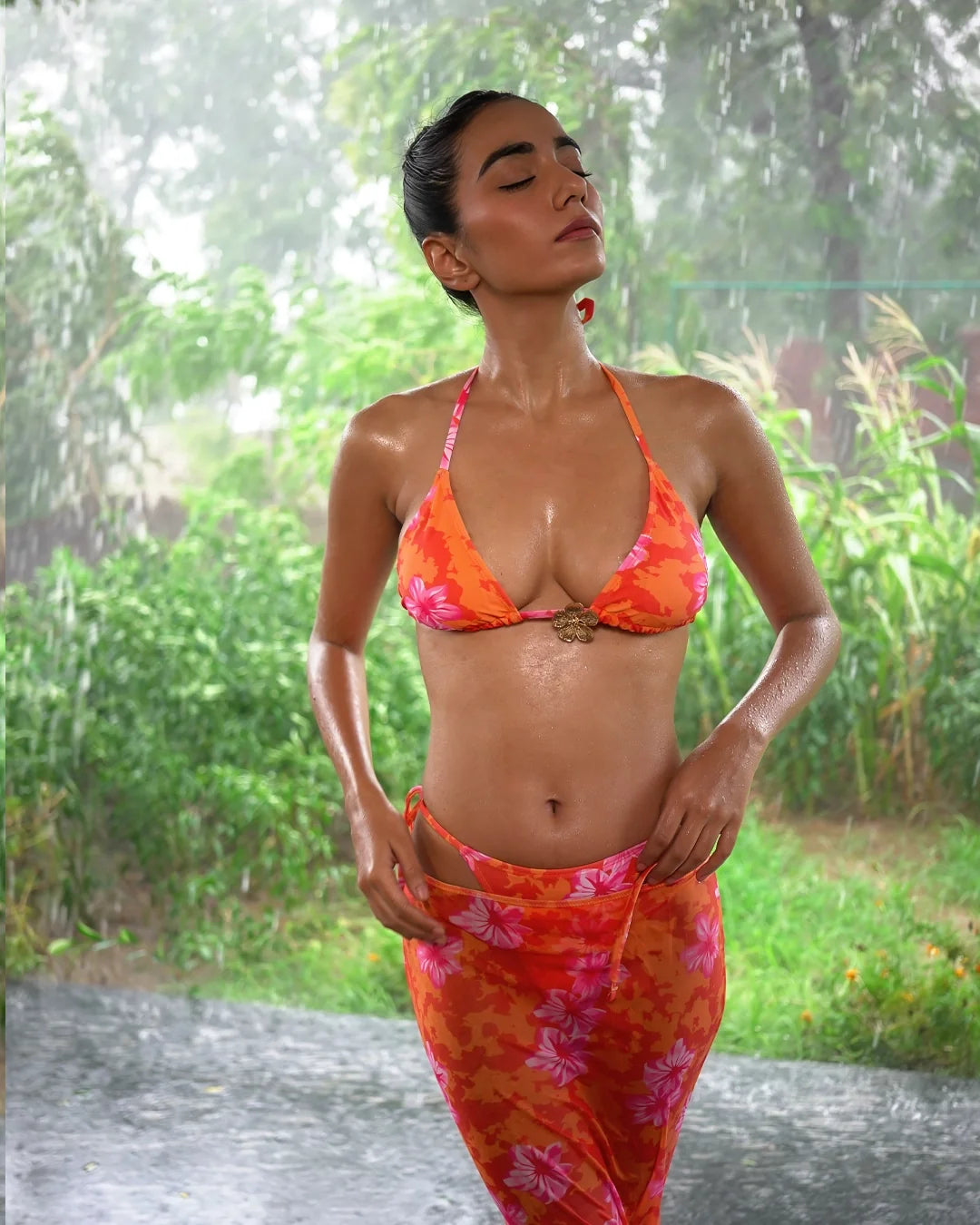 Siren Bikini set with Sarong in sunset-orange floral print, a triangle bikini worn with a matching long sarong
